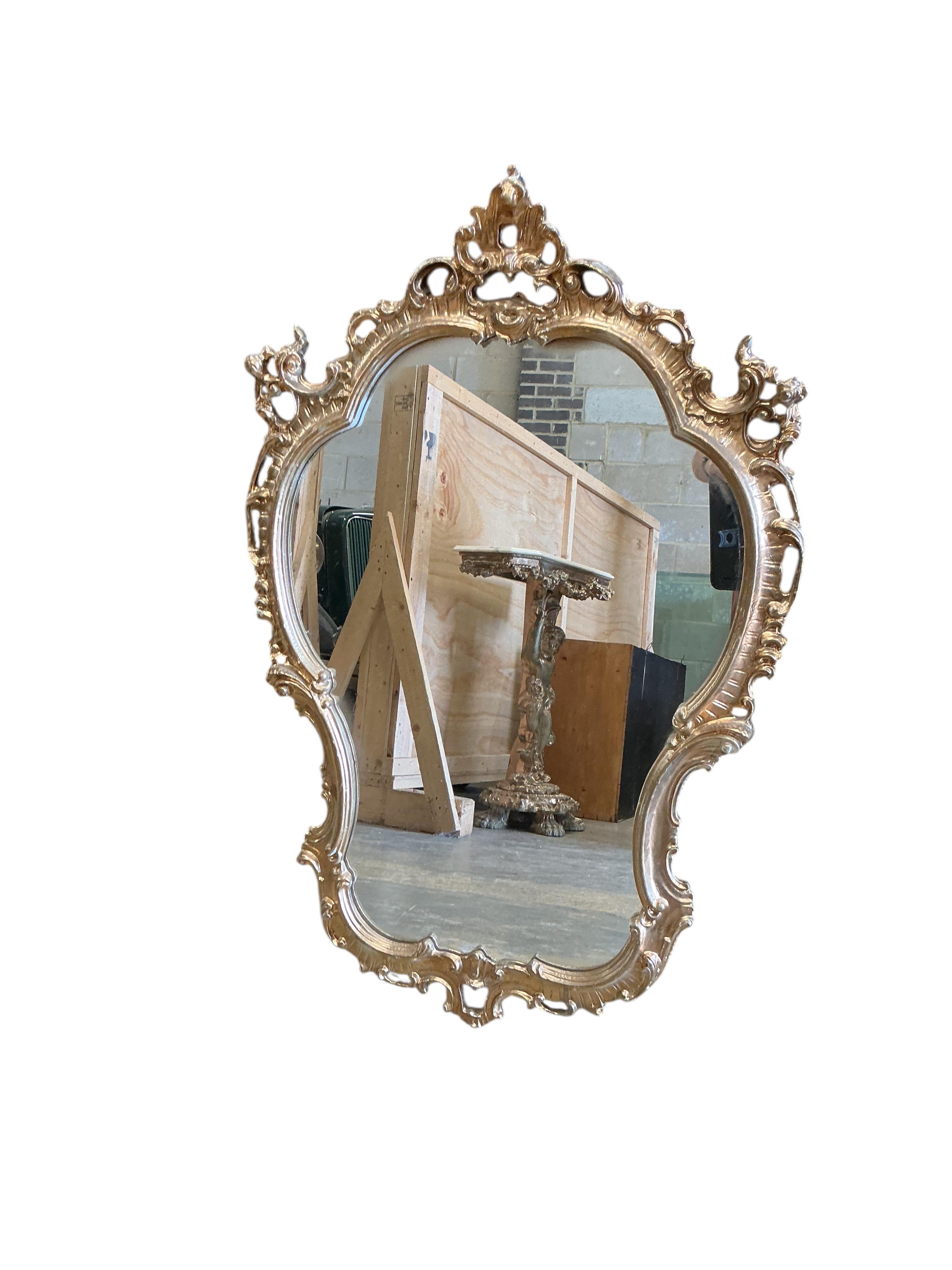 A gilt composition cherub column console table with faux marble top and a similar wall mirror, table width 73cm, depth 26cm, height 83cm.